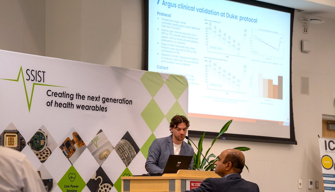 Thibault presenting at a podium in front of the ASSIST banner, Creating the next generation of health wearables. Invited talk, ASSIST Industry Meeting, NC State University, September 2026.
