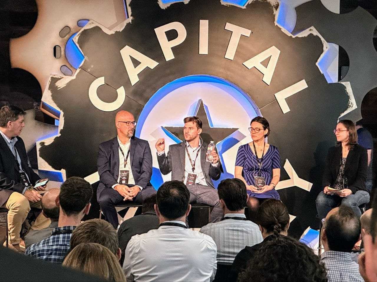 Thibault speaking on a five-person panel in front of the Capital Factory backdrop. Panelist, VERTEX Human Performance, Austin, December 2022.